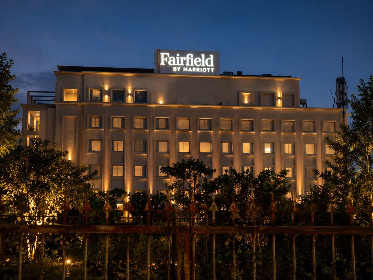 Fairfield by Marriott rooftop glow sign lit at dusk