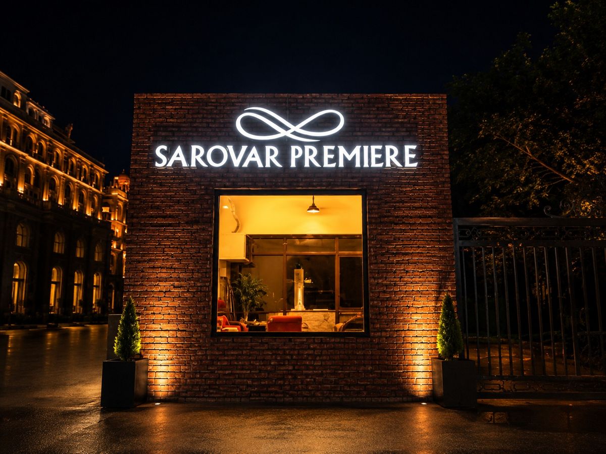 Sarovar Premiere backlit entrance signage on brick facade
